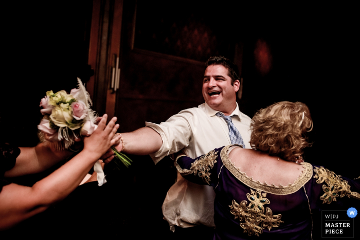 Montreal Quebec wedding photo of the bride's bouquet being passed between guests on the dance floor.