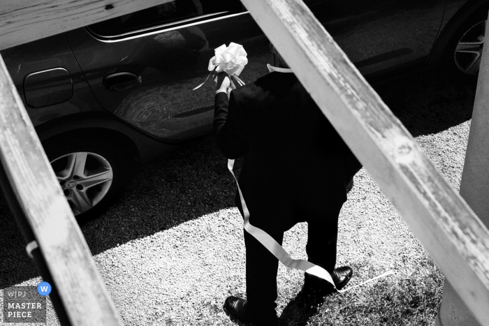 Photo by: <a href="https://www.wpja.com/contests/2017-tri2-photography-competition/flowersdecorations/2015371">Laure Boyer - France</a> This black and white photo of the groom holding the brides bouquet was captured by a Paris wedding photographer