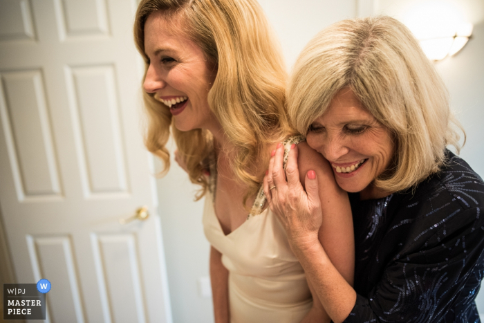 Portland Maine photographer captured a hugging moment between the bride and her mother on wedding day.