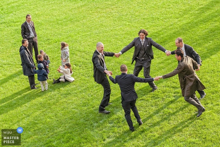 Photo by: <a href="https://www.wpja.com/contests/2012-q1-contest/reception/884551">Andrea Cittadini - Italy</a> Perugia Umbria Documentary Wedding Photographer | Image contains: guests groomsmen playing grass reception dancing kids