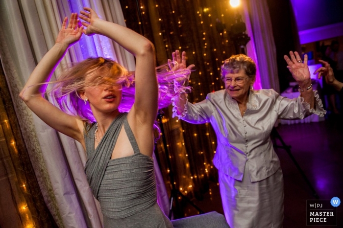 Photo by: <a href="https://www.wpja.com/contests/2013-q1-contest/dancing-action/1151511">Debra Gulbas - United States</a> Austin wedding photography - Picture of a bridesmaid and the grandmother showing their best moves on the dance floor