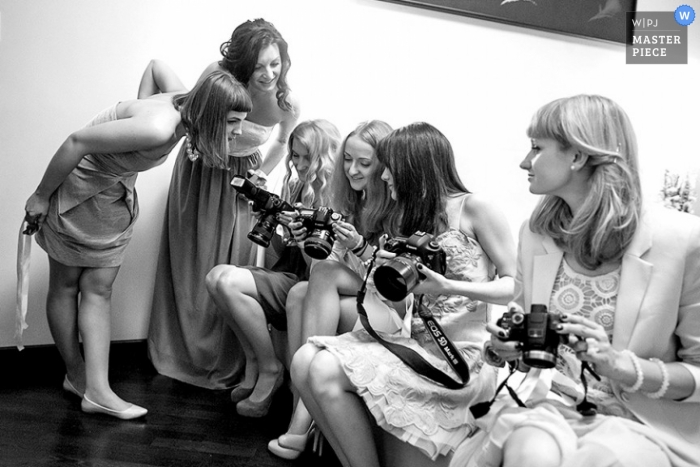 Photo by: <a href="https://www.wpja.com/contests/2013-q1-contest/full-frame-black-and-white/1127806">Emin Kuliyev - United States</a> Bronx wedding photographer captured this black and white photo of a team of photographers comparing shots after the ceremony