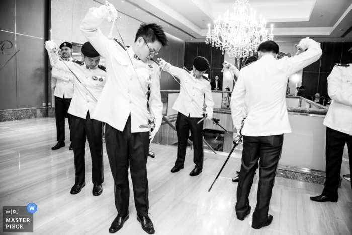 Photo by: <a href="https://www.wpja.com/contests/2013-q1-contest/full-frame-black-and-white/1130251">Charles Sng - Singapore</a> Singapore wedding photographer captured this black and white photo of the groomsmen doing a ritual with swords before the ceremony