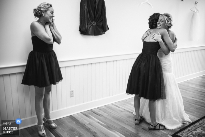 Photo by: <a href="https://www.wpja.com/contests/2013-q1-contest/full-frame-black-and-white/1138741">Amelia Phillips Hale - United States</a> Charleston wedding photographer captured this black and white photo of the bride embracing her bridesmaid before the ceremony