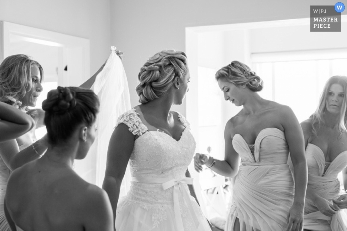 Photo by: <a href="https://www.wpja.com/contests/2013-q1-contest/full-frame-black-and-white/1139511">Mark Tolson - Australia</a> New South Wales wedding photographer captured this black and white photo of the bridesmaid helping the bride into her dress in Australia