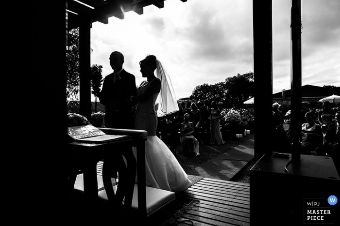 Photo by: <a href="https://www.wpja.com/contests/2013-q1-contest/full-frame-black-and-white/1142226">Marino Prieto - Brazil</a> Paraná wedding photographer captured this black and white silhouette photo of the bride and groom standing under an awning during their outdoor ceremony in Brazil