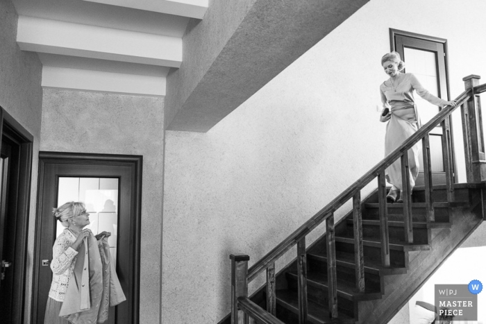 Photo by: <a href="https://www.wpja.com/contests/2013-q1-contest/full-frame-black-and-white/1148781">Eduard Gebel - Russia</a> A wedding photographer captured this black and white photo of the bride walking down a flight of stairs towards her mother