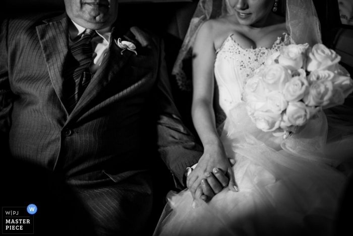 Photo by: <a href="https://www.wpja.com/contests/2013-q1-contest/full-frame-black-and-white/1156221">Wander Menezes - Brazil</a> Minas Gerais wedding photographer captured this black and white photo of the bride and her father holding hands on the ride to the ceremony