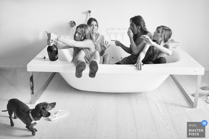 Photo by: <a href="https://www.wpja.com/contests/2013-q2-contest/animals/1159346">Daniele Vertelli - Italy</a> Arezzo Wedding Photography | Image contains: hot tub, getting ready, champagne, dog, black, white, bride, bridemaids
