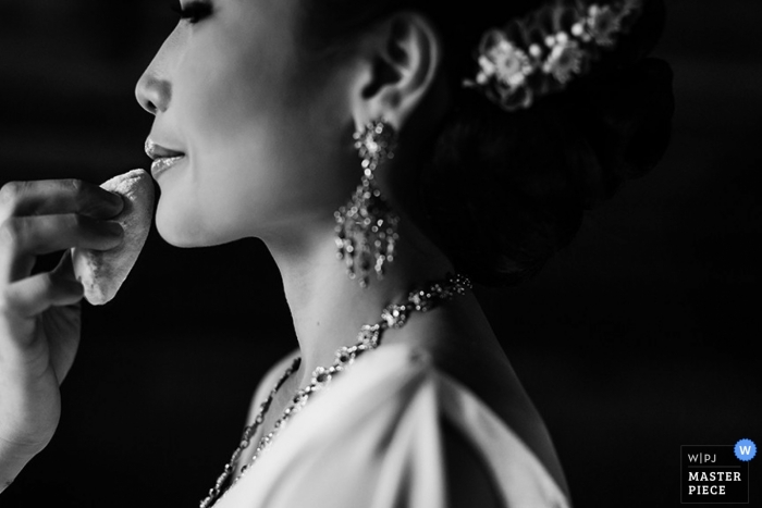 Bride having her makeup done prior to the wedding ceremony