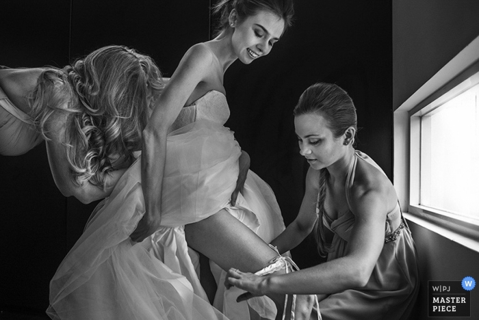 A Jakarta bride gets some help before her Java wedding ceremony in this black and white photo