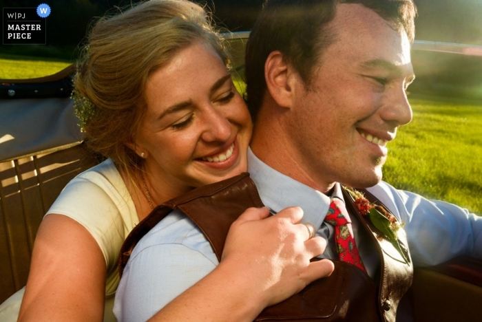 Montana wedding photographer created this beautiful portrait as the bride leans over the groom shoulder in the car as they drive away