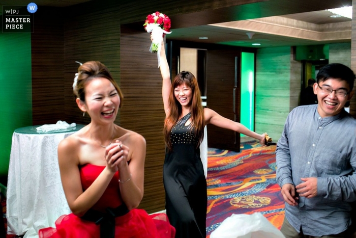 Singapore wedding photographer seized the moment in this photo of wedding guests dancing at the reception