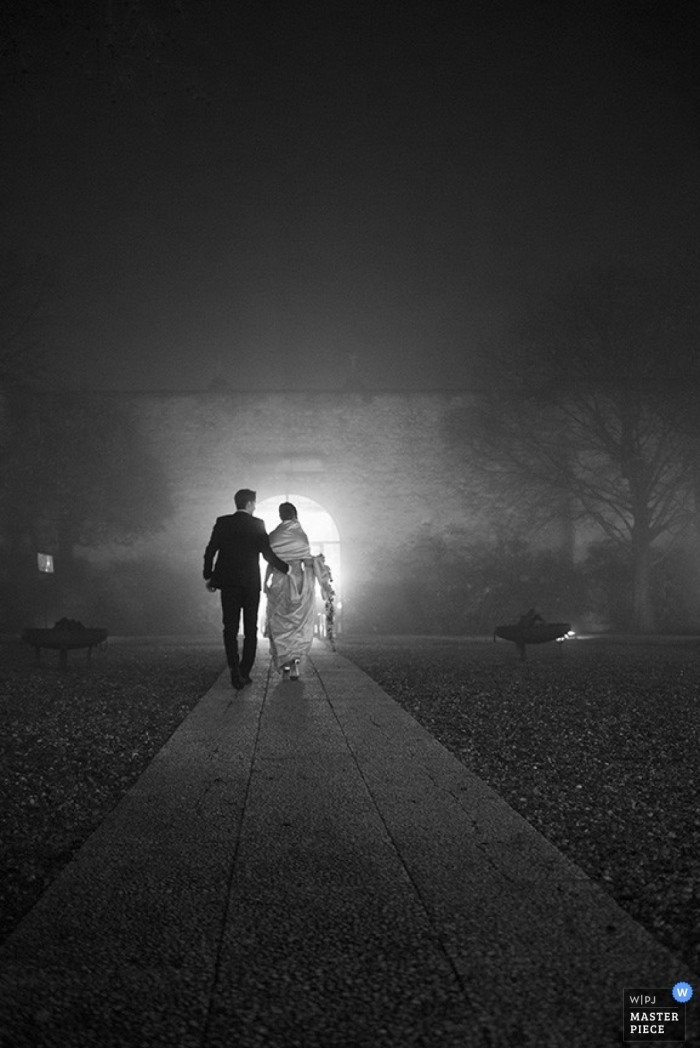Photo by: <a href="https://www.wpja.com/contests/2014-q4-photography-contest/weather/1515196">Veronica Masserdotti - Italy</a> Brescia wedding photographer seized the moment of the bride and groom walking down the path in the dark in this beautiful black and white image