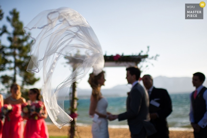 Photo by: <a href="https://www.wpja.com/contests/2014-q4-photography-contest/weather/1538596">Matt Theilen - United States</a> Lake Tahoe wedding photographer seized the moment in this photo of the brides veil being whipped around by the breeze from the lake