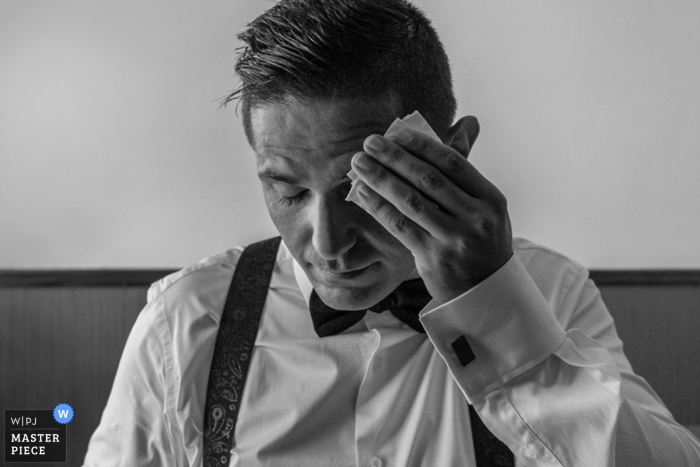 Photo by: <a href="https://www.wpja.com/contests/2014-q4-photography-contest/weather/1565396">Pedro Cabrera - Spain</a> Madrid wedding photographer seized the moment in this black and white photo of the groom wiping his brow before the ceremony