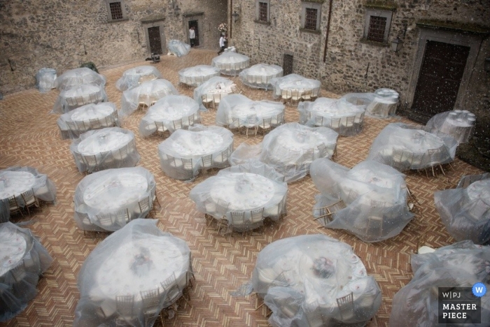Photo by: <a href="https://www.wpja.com/contests/2014-q4-photography-contest/weather/1587021">Luca Rossini - Italy</a> Tables are protected from the rain by plastic covers in this aerial shot taken by a Rome wedding photographer