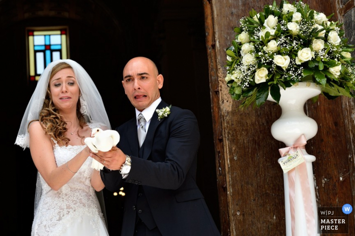 Caserta wedding photographer captured this photo of the bride and groom hesitantly releasing the dove after their ceremony