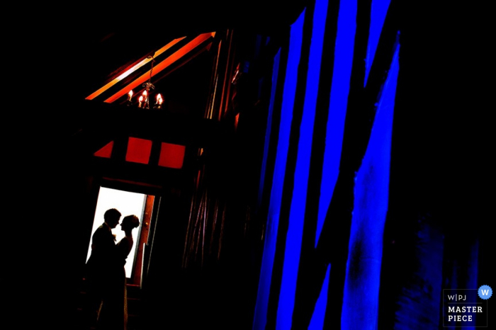 Photo by: <a href="https://www.wpja.com/contests/2015-q3-photography-contest/wildcard-portrait/1670171">Richard Howman - United Kingdom</a> Bristol bride and groom silhouetted while hugging in a doorway - England wedding portrait