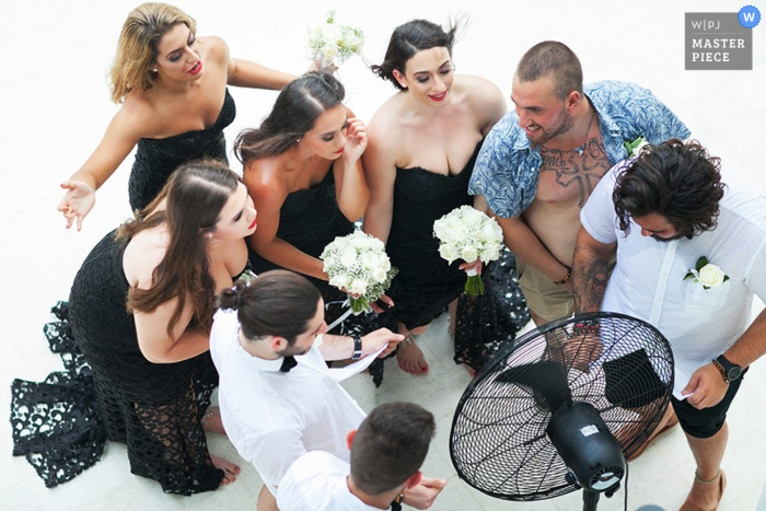 Photo by: <a href="https://www.wpja.com/contests/2015-q3-photography-contest/weather/1679276">Aht Yomyai - Thailand</a> Phuket bridal party trying to cool down in front of a fan - Thailand wedding photojournalism