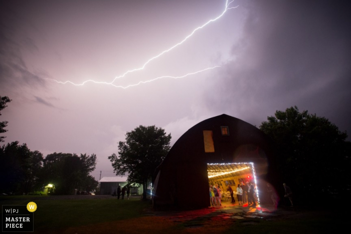 Photo by: <a href="https://www.wpja.com/contests/2015-q3-photography-contest/weather/1700201">Mark Black - United States</a> Chicago wedding reception inside during lightning storm - Illinois wedding photo