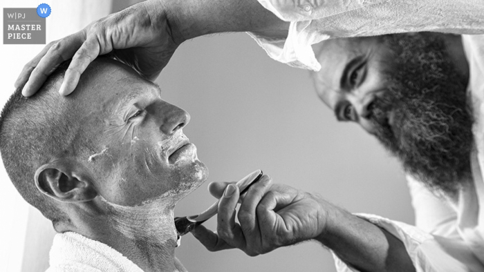 Santorini groom getting his face shaved before the wedding in South Argean Santorini groom getting shaved before the wedding - South Argean wedding photography