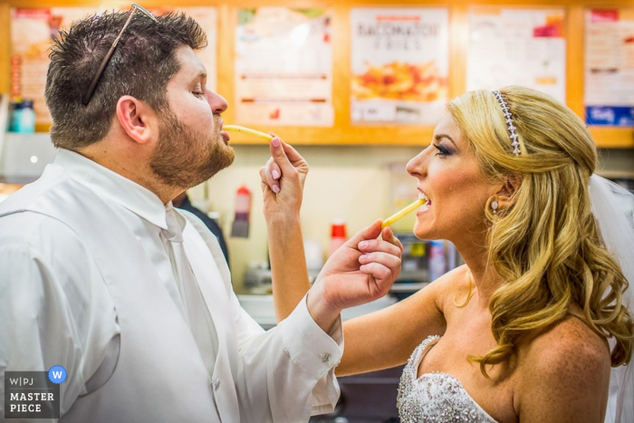 Philadelphia-Braut und -bräutigam, die Pommes-Frites - Pennsylvania-Hochzeits-Fotojournalismus sich einziehen