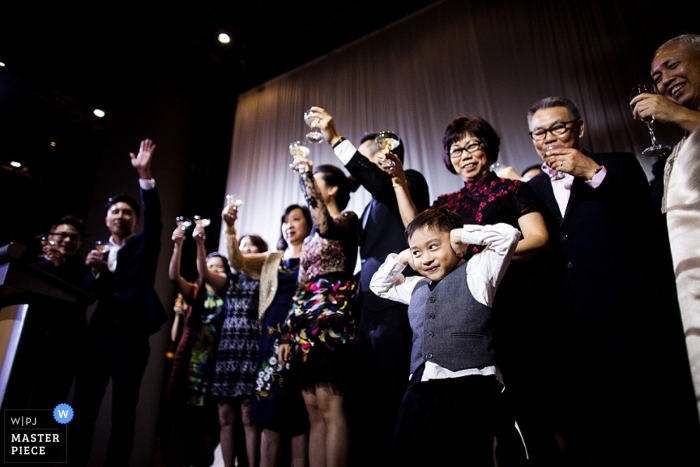 Photo by: <a href="https://www.wpja.com/contests/2015-q4-photography-contest/toastingspeeches/1709646">ChuianFeng Lui - Singapore</a> Singapore bride and groom make a toast at the reception | Asia wedding photo