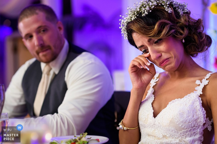 Photo by: <a href="https://www.wpja.com/contests/2015-q4-photography-contest/toastingspeeches/1741776">Daniel Moyer - United States</a> Arezzo bride and groom listen to emotional reception speeches | Tuscany wedding photo