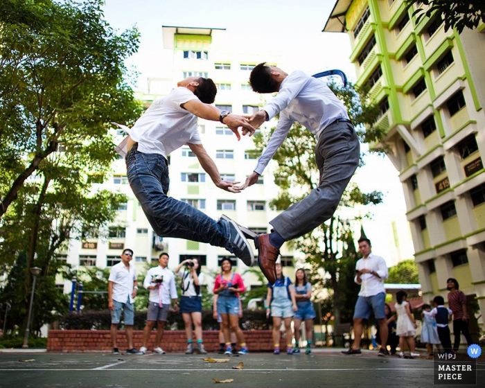 Photo by: <a href="https://www.wpja.com/contests/2015-q4-photography-contest/symmetry/1709666">ChuianFeng Lui - Singapore</a> Singapore groom and friend pose for the camera | Asia wedding photography
