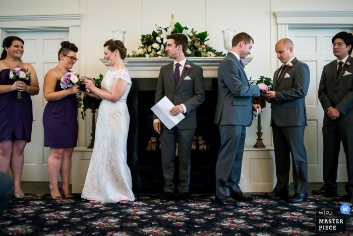 Photo by: <a href="https://www.wpja.com/contests/2015-q4-photography-contest/symmetry/1710671">Antonio Rocha - United States</a> Atlanta bride and groom take their rings during the ceremony | Georgia wedding photography