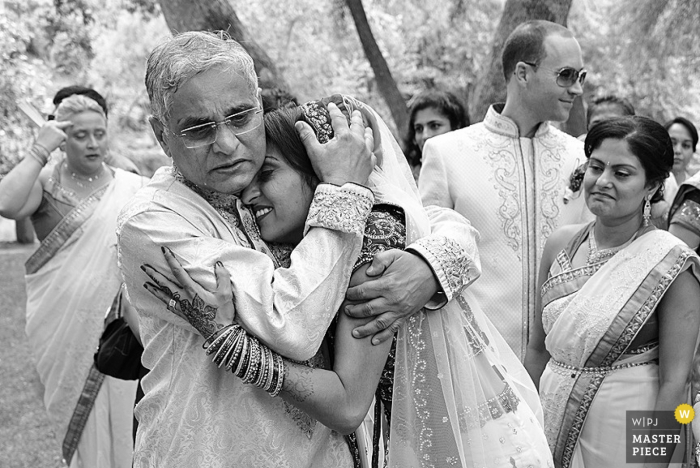 Photo by: <a href="https://www.wpja.com/contests/2015-q4-photography-contest/ceremony/1723106">Tina Wright - United States</a> Phoenix bride and father hug each other at the wedding | Arizona wedding photo