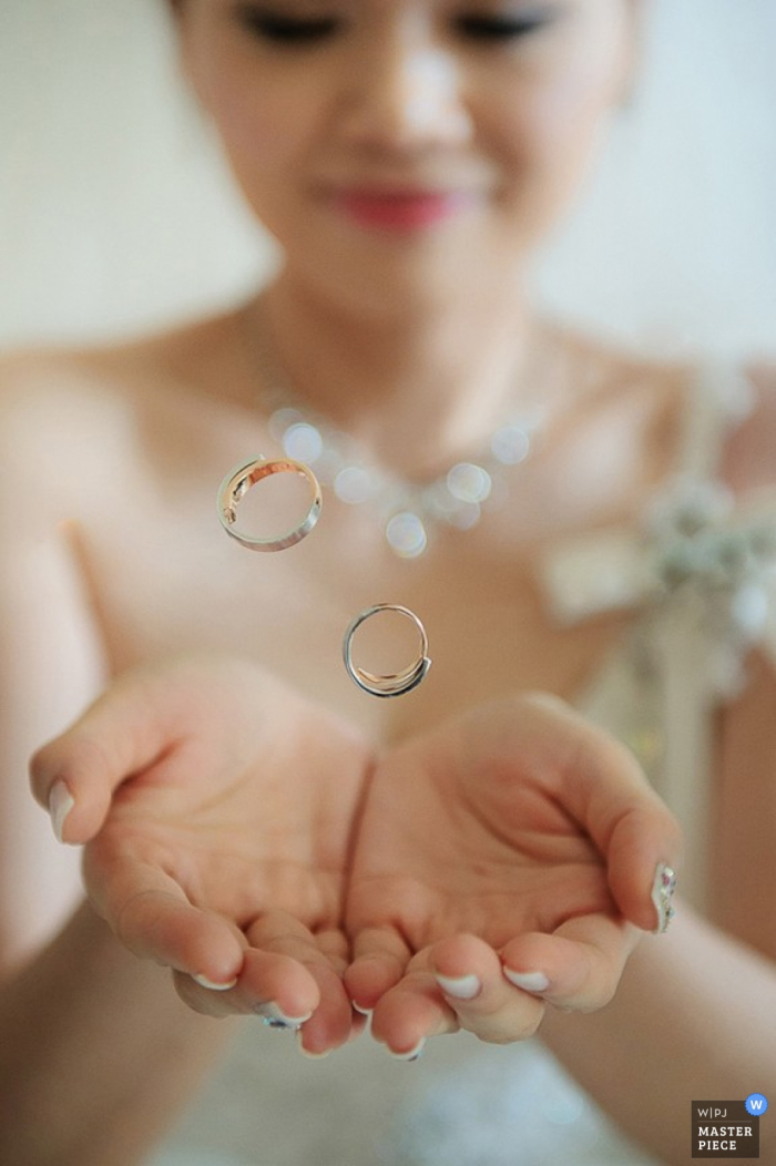 Photo by: <a href="https://www.wpja.com/contests/2015-q4-photography-contest/ring-details/1715451">Minifeel Lu - Taiwan</a> Taipei woman has wedding rings floating in her hands | Taiwan wedding photo