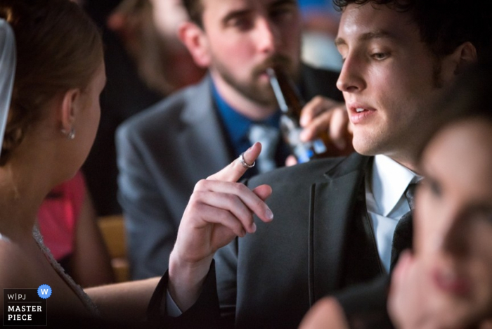 Omaha groom looking at his ring at the reception | Nebraska wedding photo