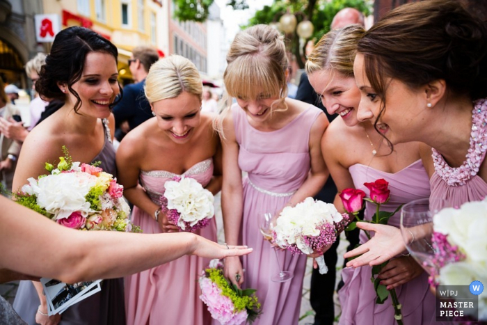 Photo by: <a href="https://www.wpja.com/contests/2015-q4-photography-contest/ring-details/1747411">Thomas Weber - Germany</a> Lower Saxony bridesmaids look at the brides ring after the ceremony | Germany wedding photojournalist