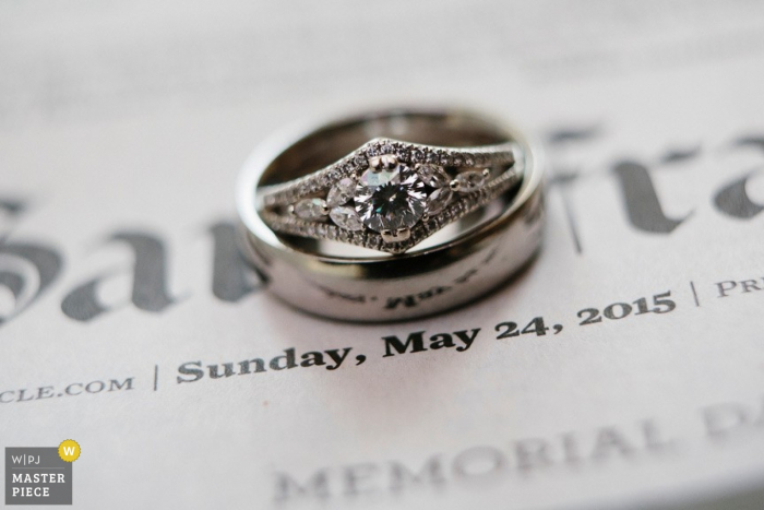 Photo by: <a href="https://www.wpja.com/contests/2015-q4-photography-contest/ring-details/1764746">Scott MacDonald - United States</a> San Jose wedding photography detail of rings on newspaper