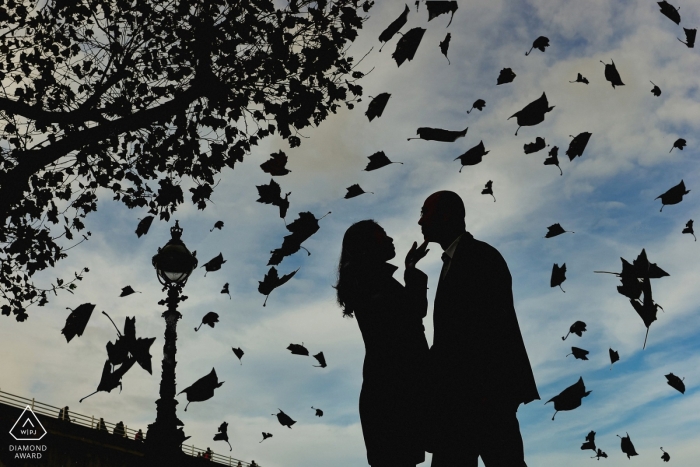 Photo by: <a href="https://www.wpja.com/photos/diamond-award-top-wedding-engagement-photographer/2174006">Ashley Davenport - Castle Dongington Derbyshire Silhouette of engaged couple within a shower of leaves during a pre-wedding photo session