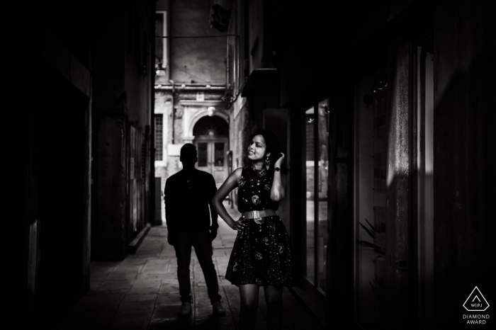 Czech Republic Alley creates a moody feel to this Black and white engagement portrait 