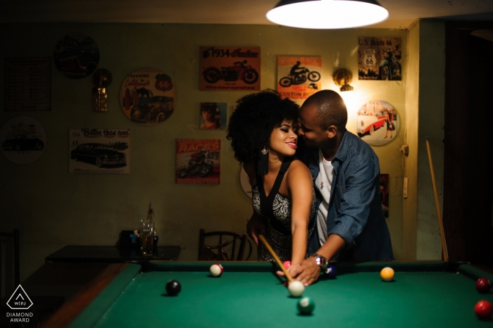 Photo by: <a href="https://www.wpja.com/photos/diamond-award-top-wedding-engagement-photographer/2168306">Gustavo Lucena - Brasilia Distrito Federal BrasÃlia, Federal District Wedding Engagement Photography with a couple playing pool