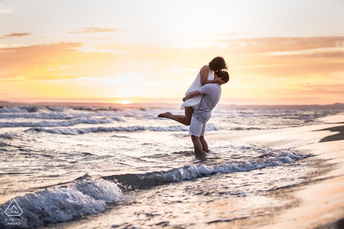 Miami Florida Beach engagement Photos | a couple plays in the small waves at the beach before sunset