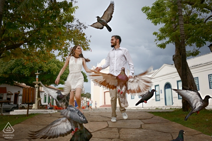 Brazil Engagement Photographer | Couple walking in the park through the birds