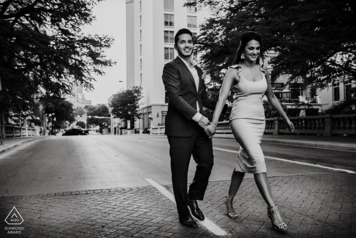 San Antonio couple walks down the stree during their urban portrait session