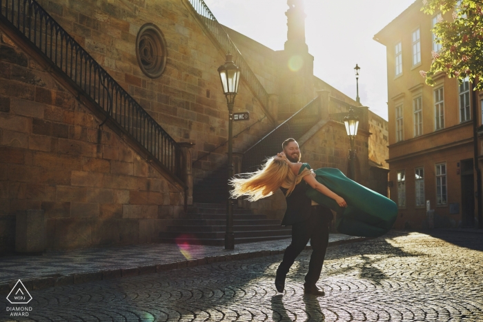 Una pareja de la República Checa pasa en la plaza del pueblo mientras bailan durante su sesión de retratos antes de la boda.