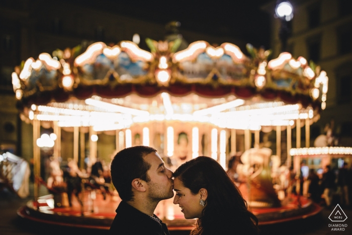 Photo by: <a href="https://www.wpja.com/photos/diamond-award-top-wedding-engagement-photographer/2211596">Daniel Monteiro - Portugal Wedding Photographer</a> A Carnival carousel creates a symmetrical backdrop this Portugal pre-wedding portrait