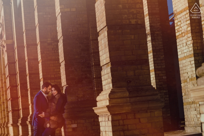 Photo by: <a href="https://www.wpja.com/photos/diamond-award-top-wedding-engagement-photographer/2208661">Rohit Gautam - United Kingdom Wedding Photographer</a> Brick pillars in London add to the starkness of this outdoor engagement portrait