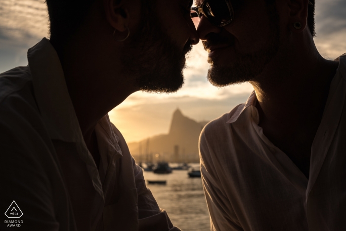 Rio de Janeiro engagement portrait at sunset near the water with boats Rio de Janeiro engagement portrait at sunset near the water with boats