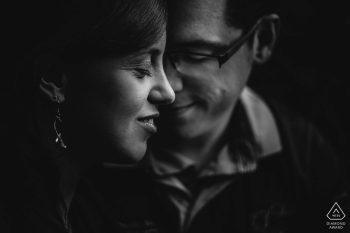 Her profile with her fiancé gazing down make for a very intimate black-and-white engagement portrait Her profile with her fiancé gazing down make for a very intimate black-and-white engagement portrait