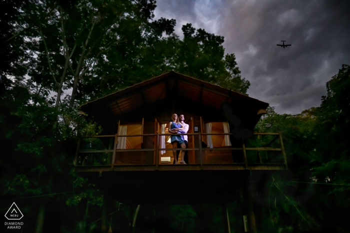 Perched in a tree house this Brazil engaged couple poses for a pre-wedding portrait