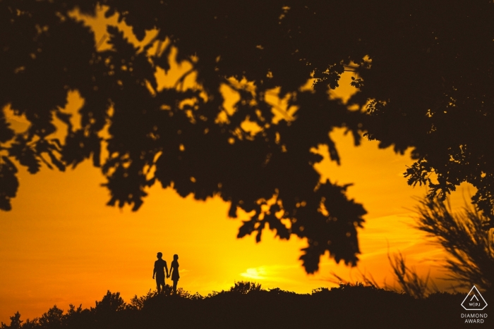 Une silhouette de Ljubljana, coucher de soleil, séance de fiançailles encadrée montrant qu'ils sont plus forts ensemble silhouette, coucher de soleil, tournage de fiançailles encadré | Plus forts ensemble