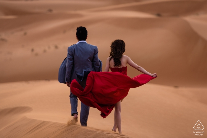 Photo by: <a href="https://www.wpja.com/photos/diamond-award-top-wedding-engagement-photographer/2256486">Bindi Richardson - United Arab Emirates Wedding Photographer</a> Desert Engagement Session | The Red Dress Photography